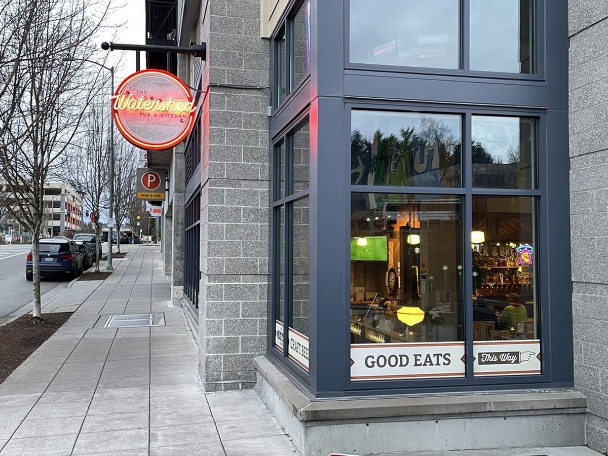The neon sign and corner windows of The Watershed Pub & Kitchen, a Cloud City Coffee wholesale customer in Seattle